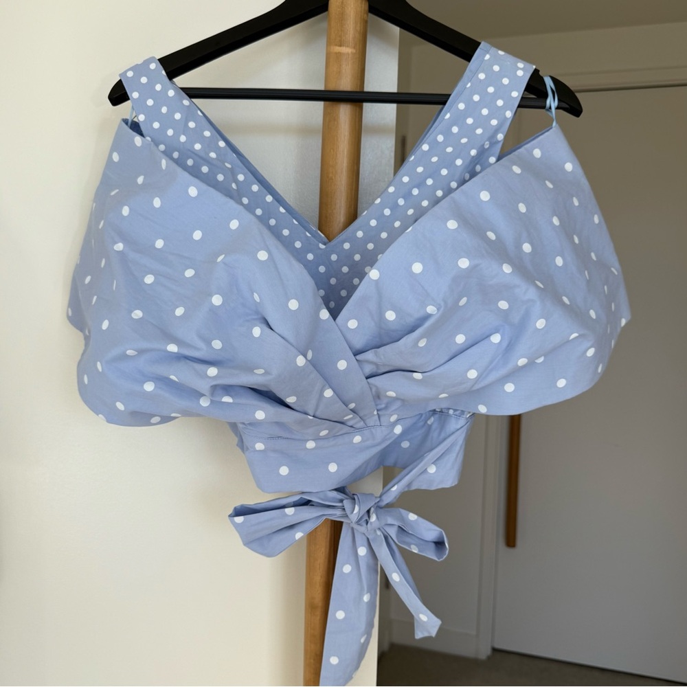 Blue Polka Dot Top with a tie at the waist. New condition, but no tag. XS size.